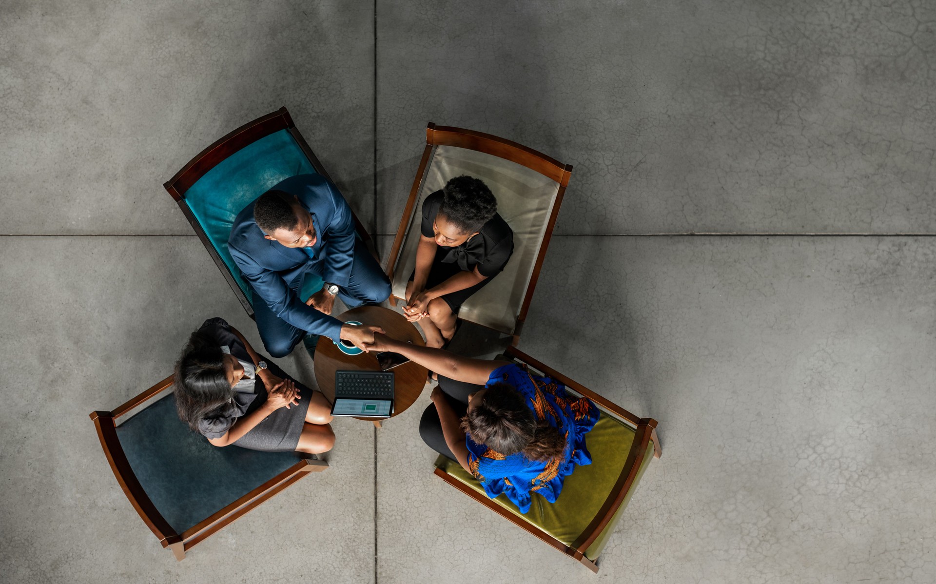 Two North African businesspeople shaking hands in an office lounge
